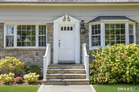 a front view of a house with a garden