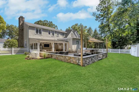 a view of a house with a deck and a big yard
