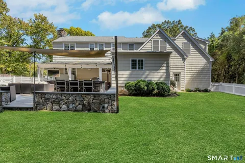 a front view of house with yard and outdoor seating