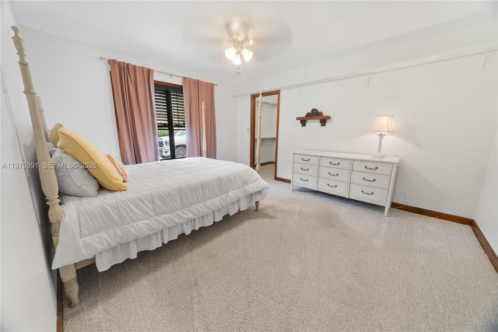 1872 Southeast Colony Way Jupiter, FL 33478 - Photo 22 of 26 a bedroom with a bed dresser and window
