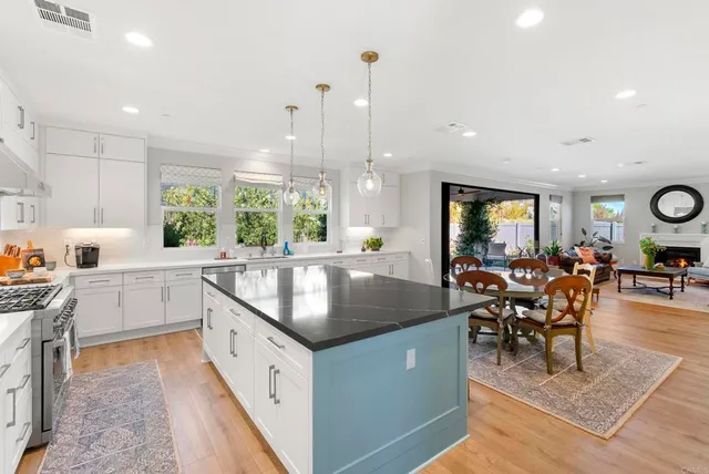 a large kitchen with lots of counter space and furniture