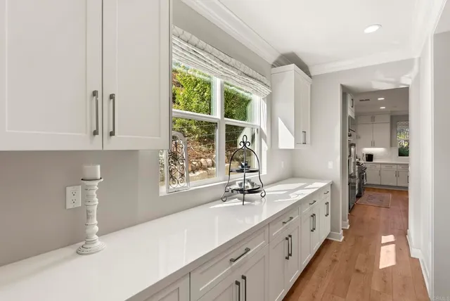 a spacious bathroom with double vanity and a large mirror