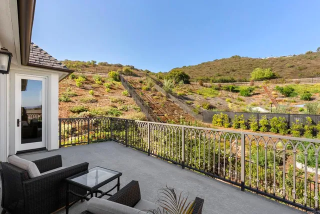 a view of a balcony with furniture