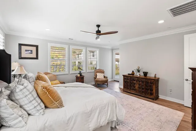 a spacious bedroom with a bed and a chandelier