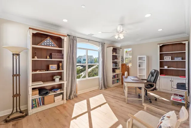 a work room with furniture and large window