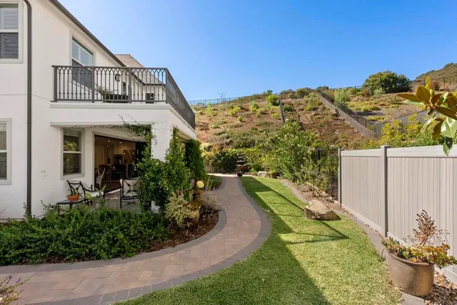 a view of a house with a small yard and plants