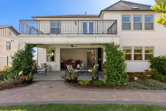 a view of a house with sitting area and garden