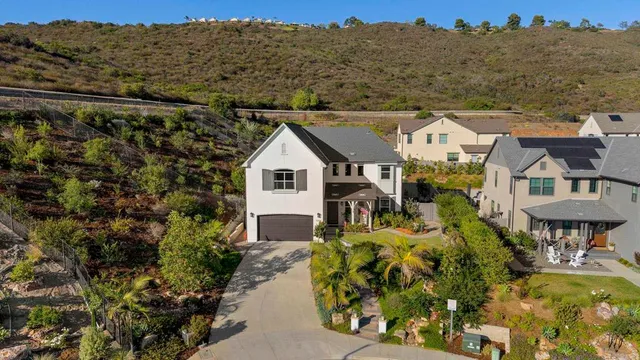 a view of a white house with a yard