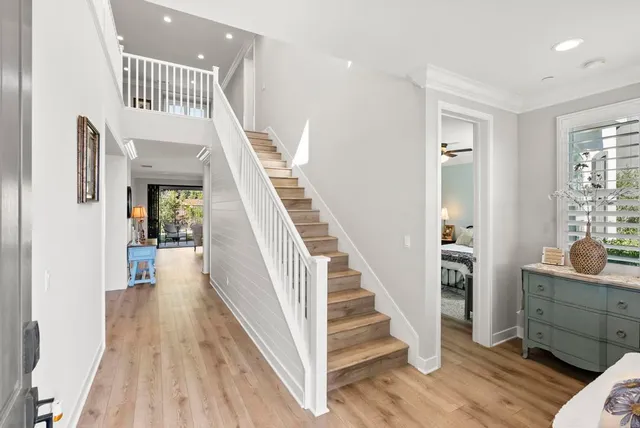 a view of entryway and hall with wooden floor