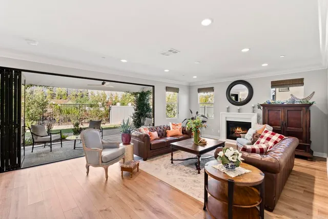 a living room with fireplace furniture and a floor to ceiling window