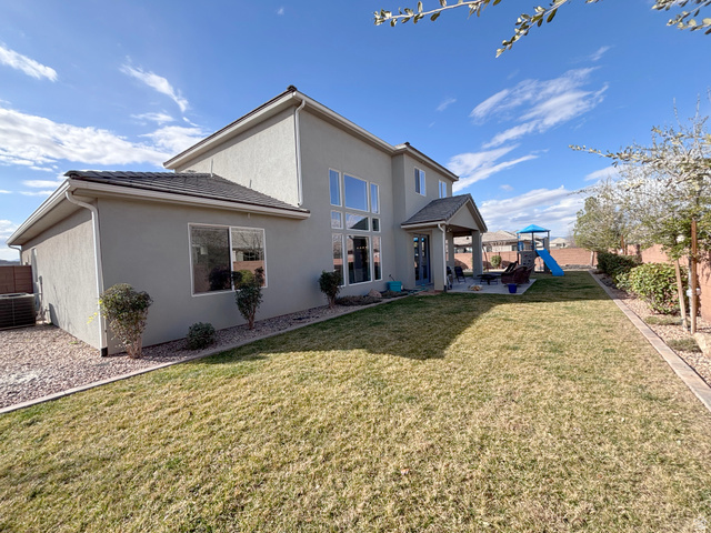 429 East Treasure Road Washington, UT 84780 - Photo 28 of 36 Rear view of property with a fenced backyard, a playground, stucco siding, a patio, and a gazebo