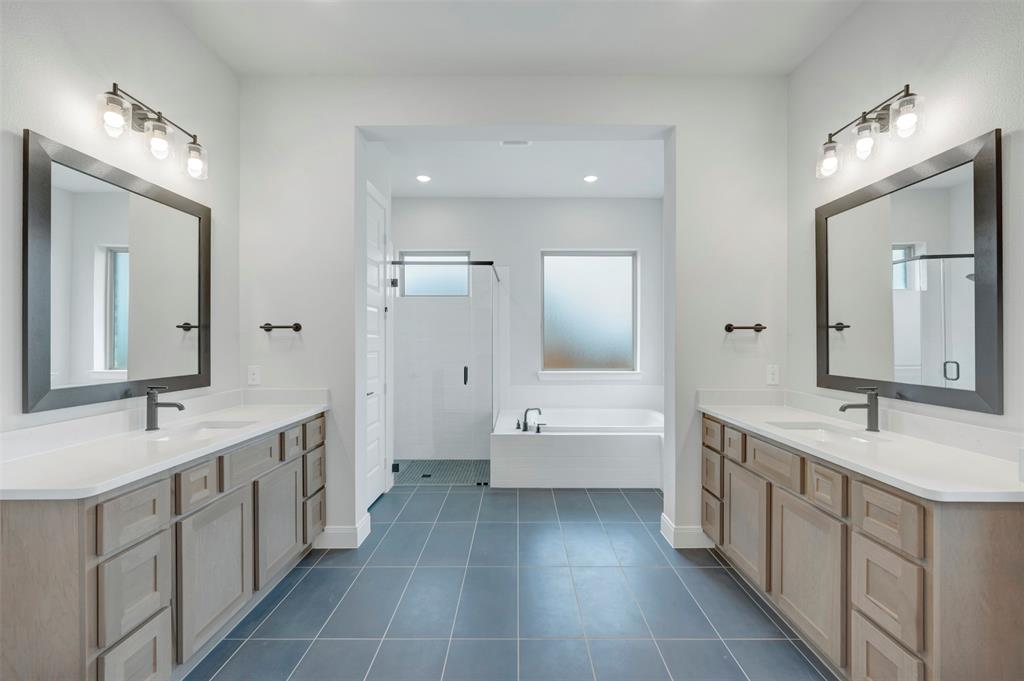 1103 Vista Way Rockwall, TX 75087 - Photo 13 of 26 a large bathroom with a double vanity sink a large mirror and a shower