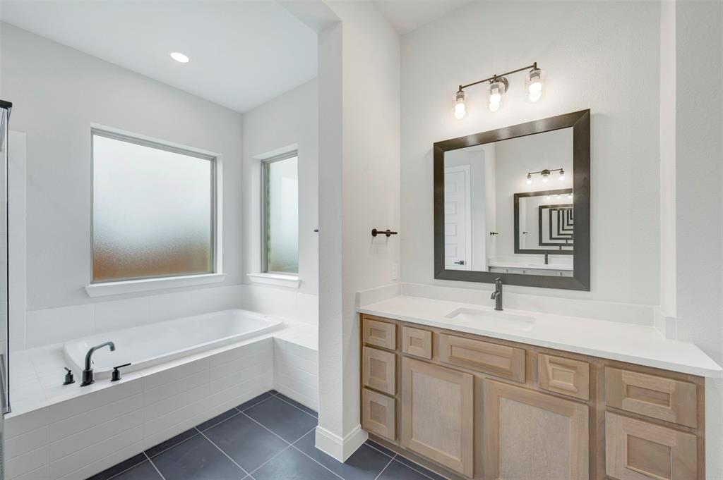 1103 Vista Way Rockwall, TX 75087 - Photo 15 of 26 a bathroom with a sink and a mirror