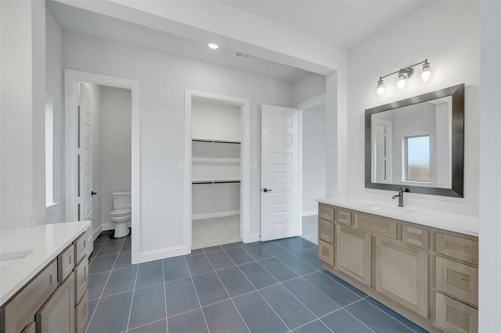 1103 Vista Way Rockwall, TX 75087 - Photo 16 of 26 a spacious bathroom with a double vanity sink a mirror and a shower