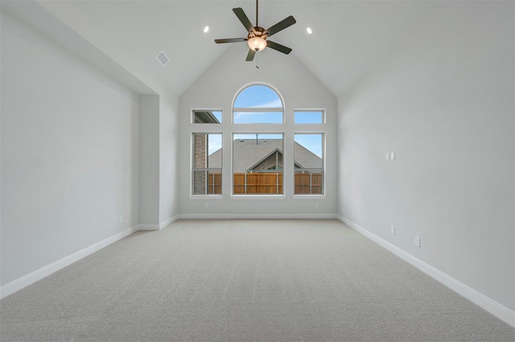 1103 Vista Way Rockwall, TX 75087 - Photo 9 of 26 an empty room with a ceiling fan and a window