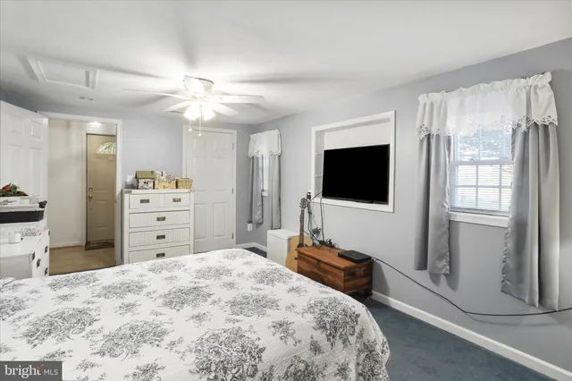 a kitchen with stainless steel appliances a stove top oven a sink a counter space and a window