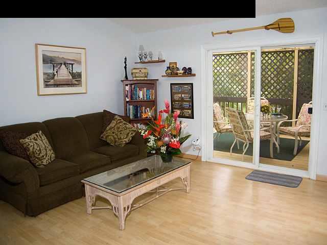 1667 South Kihei Road, Unit C Kihei, HI 96753 - Photo 1 of 5 a living room with furniture and a floor to ceiling window