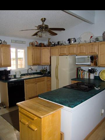 1667 South Kihei Road, Unit C Kihei, HI 96753 - Photo 2 of 5 a kitchen with stainless steel appliances granite countertop a sink a stove and a refrigerator