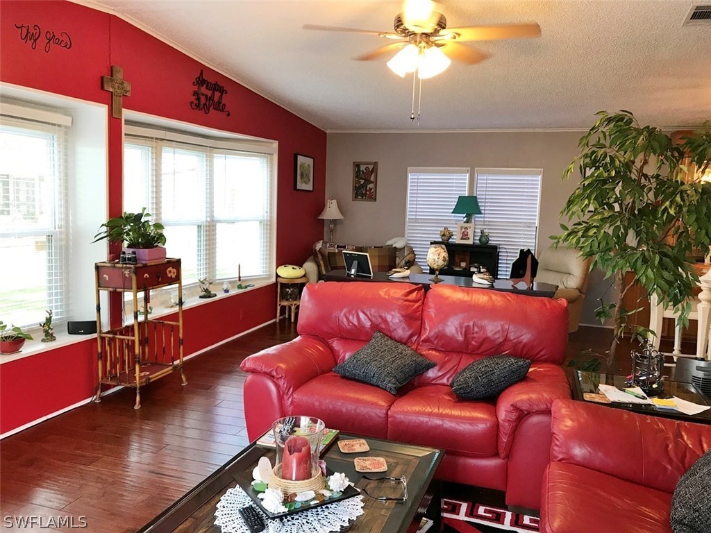 10441 Circle Pine Road North Fort Myers, FL 33903 - Photo 1 of 20 a living room with furniture a large window and a chandelier