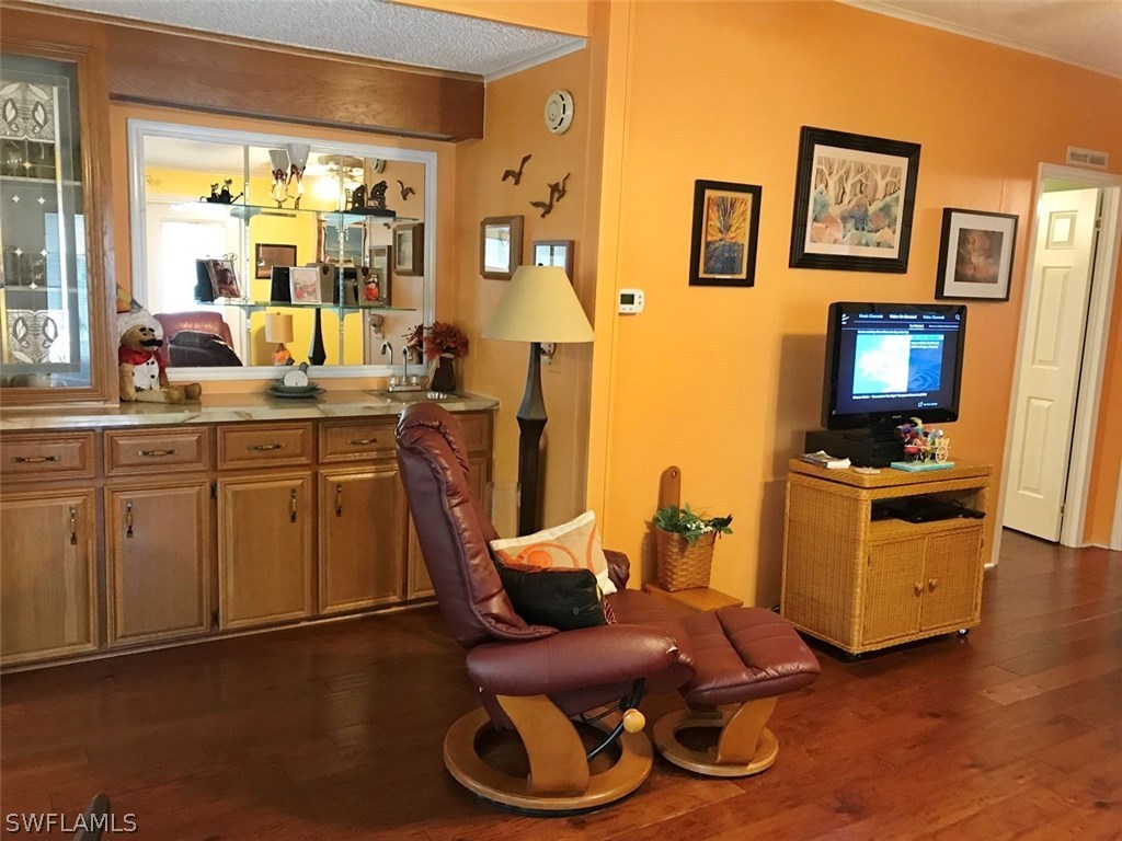 10441 Circle Pine Road North Fort Myers, FL 33903 - Photo 12 of 20 a room with furniture a flat screen tv and a window