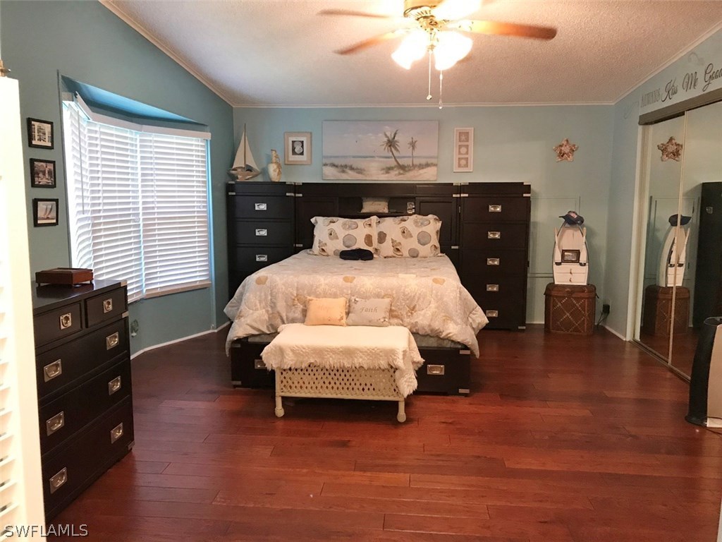 10441 Circle Pine Road North Fort Myers, FL 33903 - Photo 13 of 20 a bedroom with a bed and wooden floor