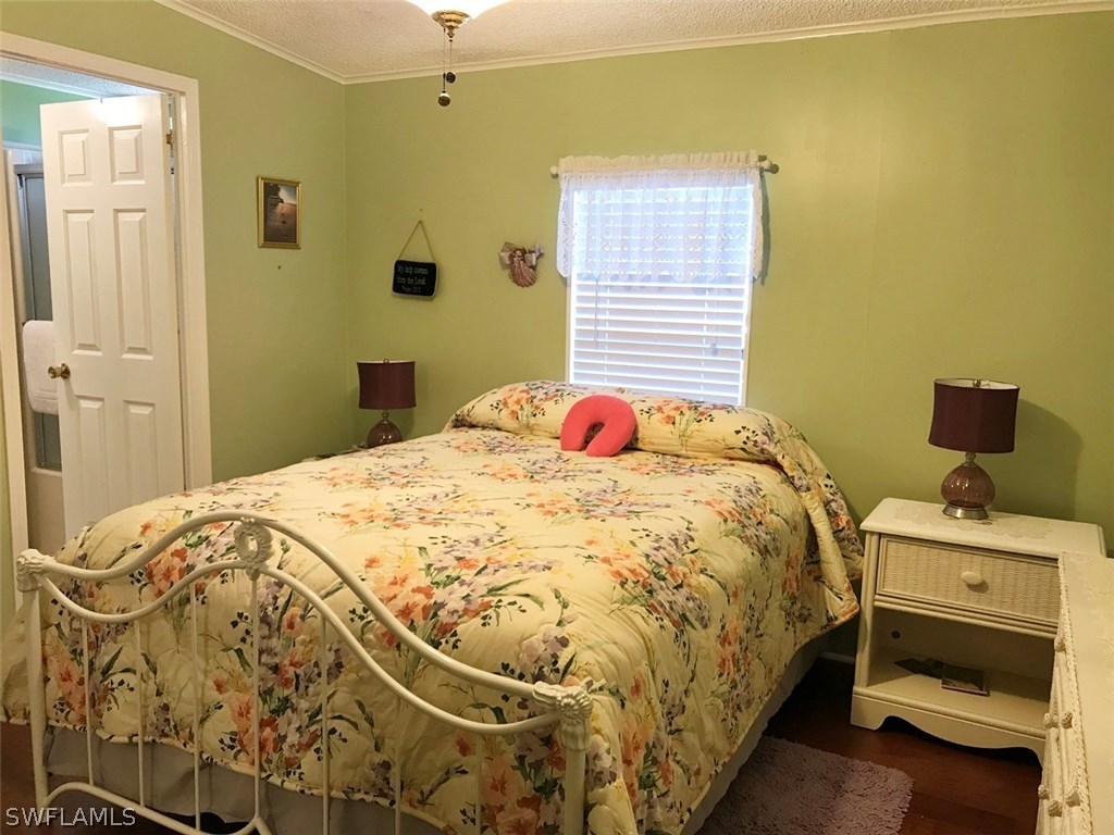 10441 Circle Pine Road North Fort Myers, FL 33903 - Photo 15 of 20 a bedroom with a bed and a window