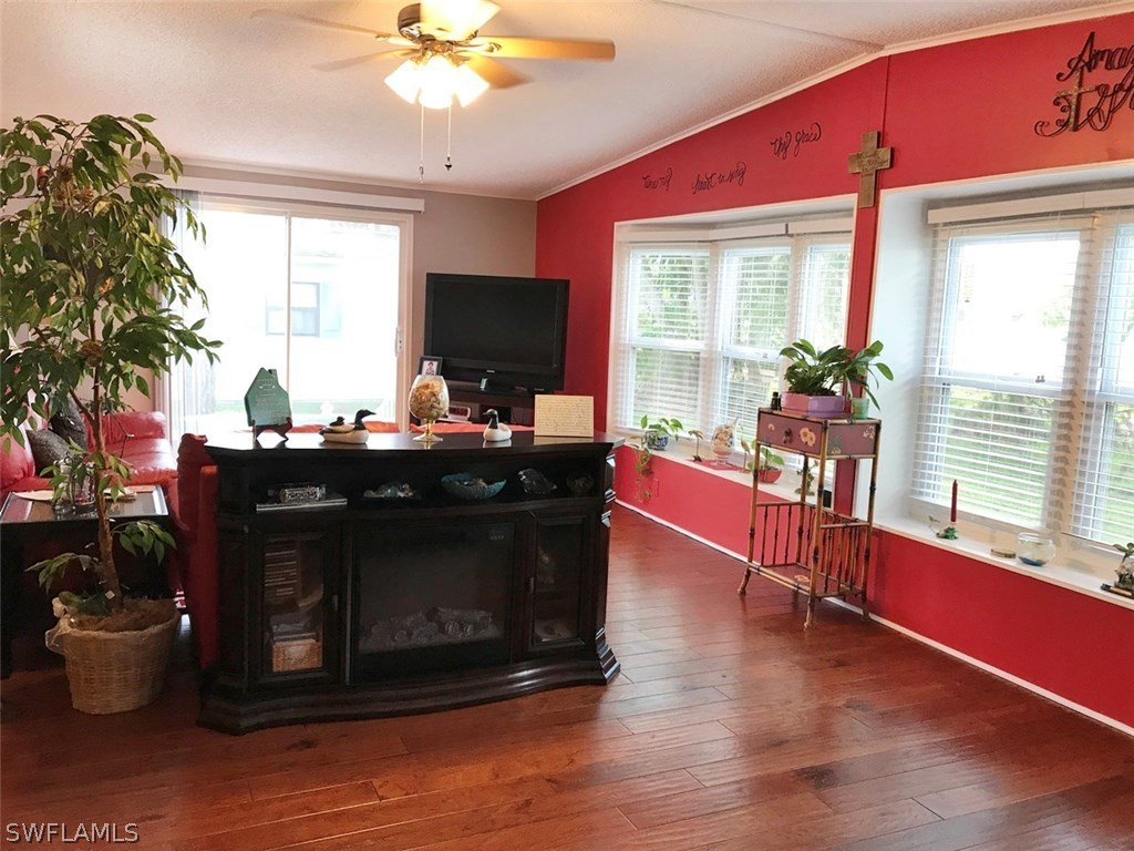 10441 Circle Pine Road North Fort Myers, FL 33903 - Photo 2 of 20 a living room with furniture and a flat screen tv