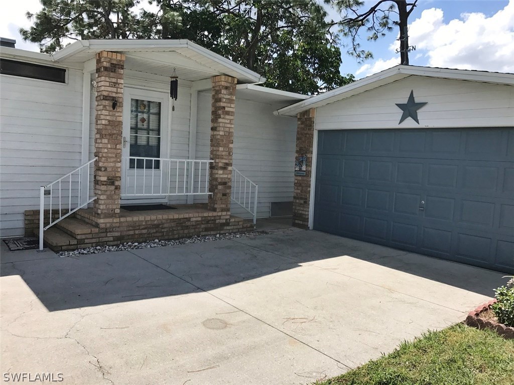 10441 Circle Pine Road North Fort Myers, FL 33903 - Photo 5 of 20 a view of a house with a yard