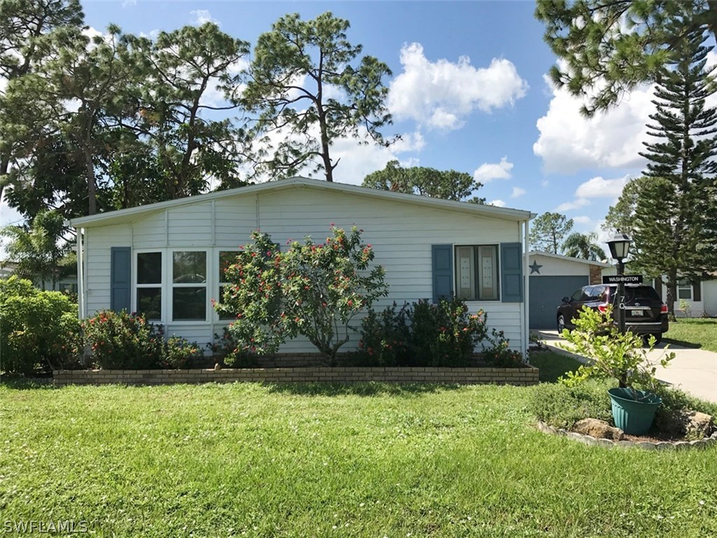 10441 Circle Pine Road North Fort Myers, FL 33903 - Photo 6 of 20 front view of a house with a garden