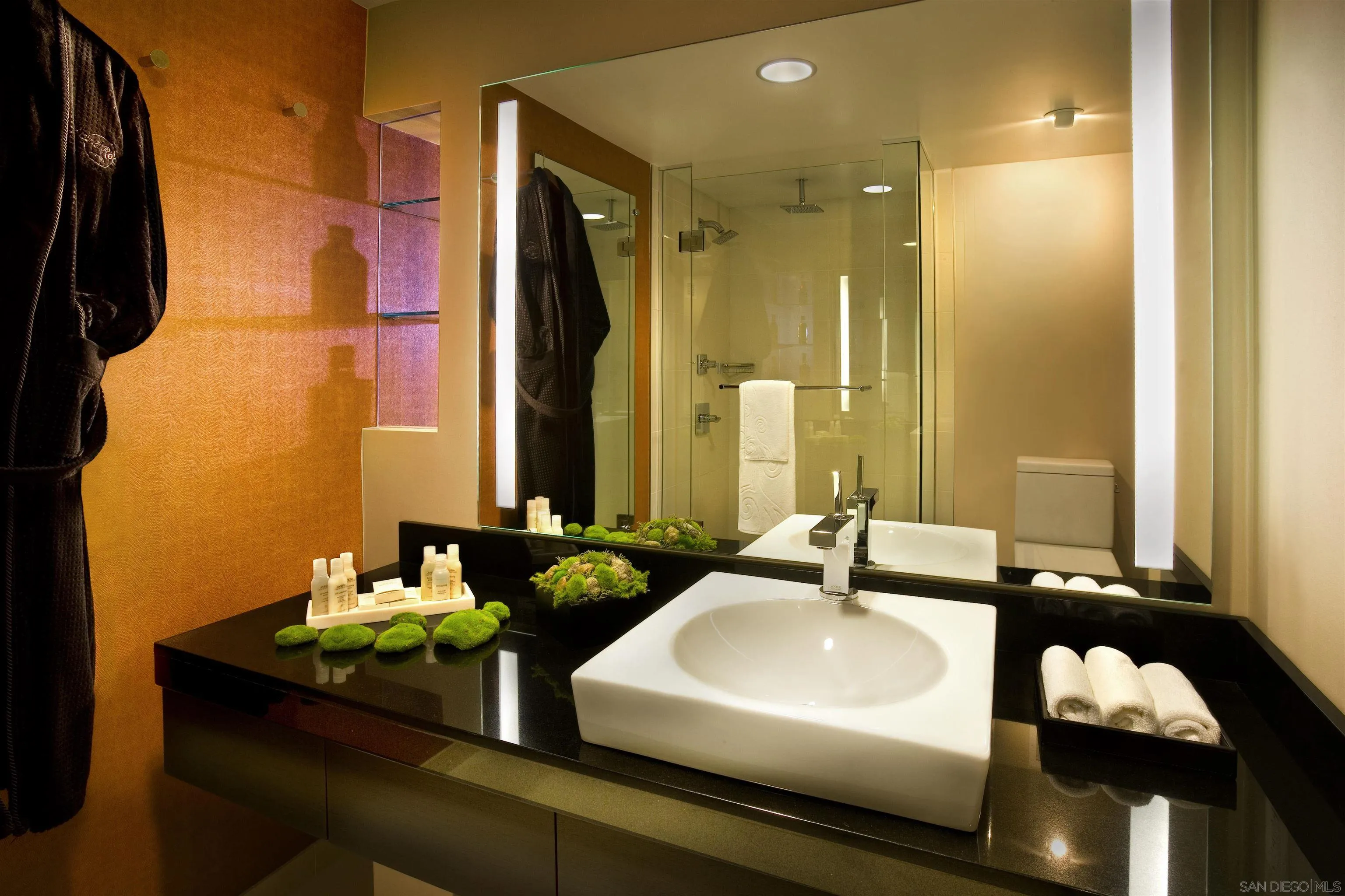 207 Fifth Avenue, Unit 507 San Diego, CA 92101 - Photo 3 of 12 a bathroom with a sink and a mirror