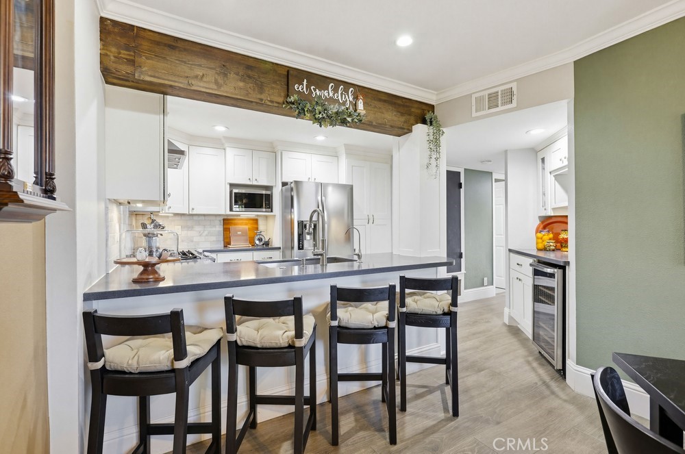 47 Vía Lavendera Rancho Santa Margarita, CA 92688 - Photo 15 of 40 a kitchen with a table and chairs in it
