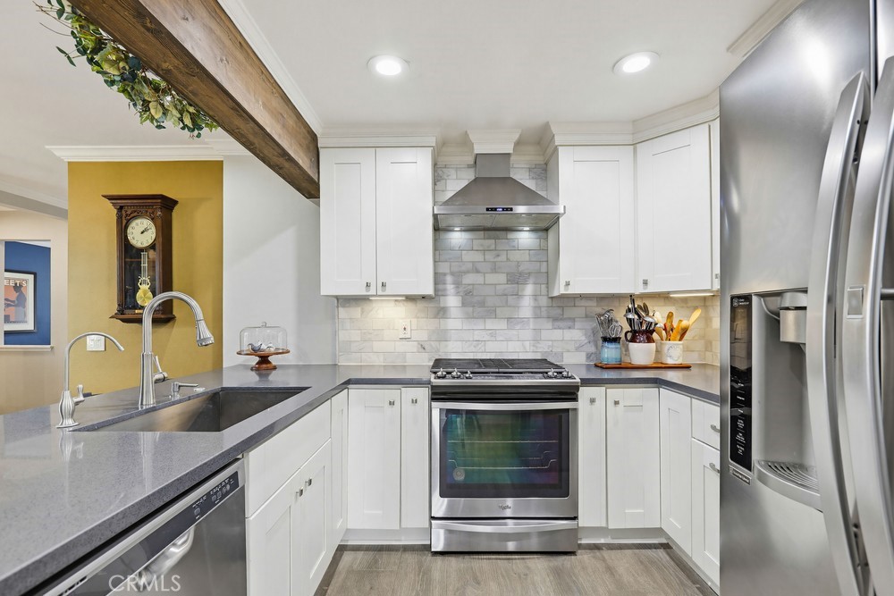 47 Vía Lavendera Rancho Santa Margarita, CA 92688 - Photo 17 of 40 a kitchen with stainless steel appliances a sink stove and refrigerator
