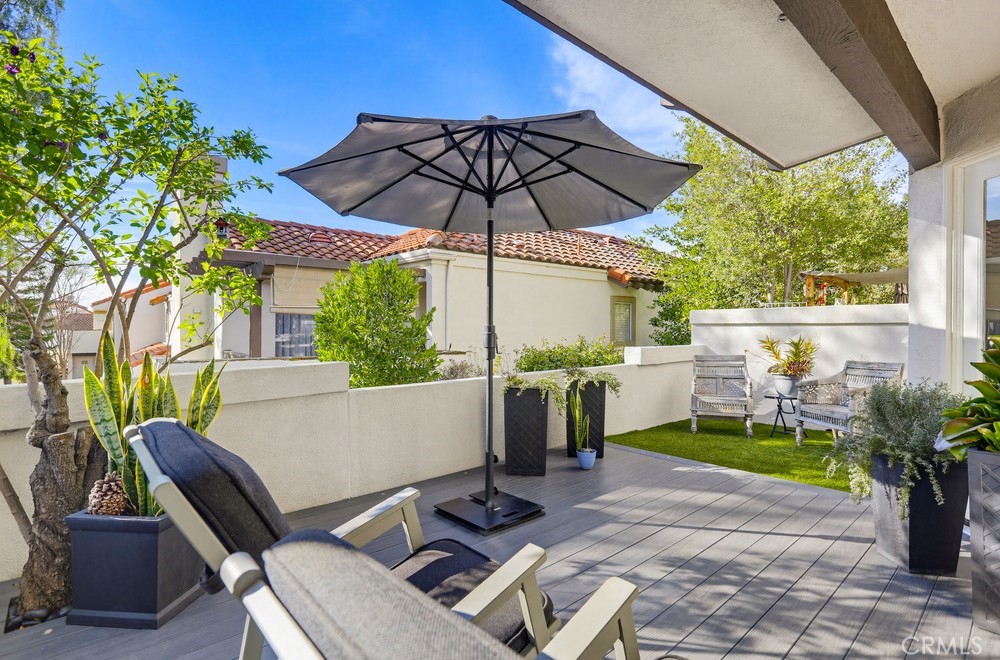47 Vía Lavendera Rancho Santa Margarita, CA 92688 - Photo 29 of 40 a view of an outdoor sitting area with couch and umbrella