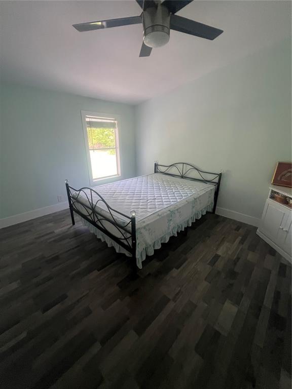 5855 Jack Brack Road St. Cloud, FL 34771 - Photo 64 of 86 a bed sitting in a bedroom next to a window