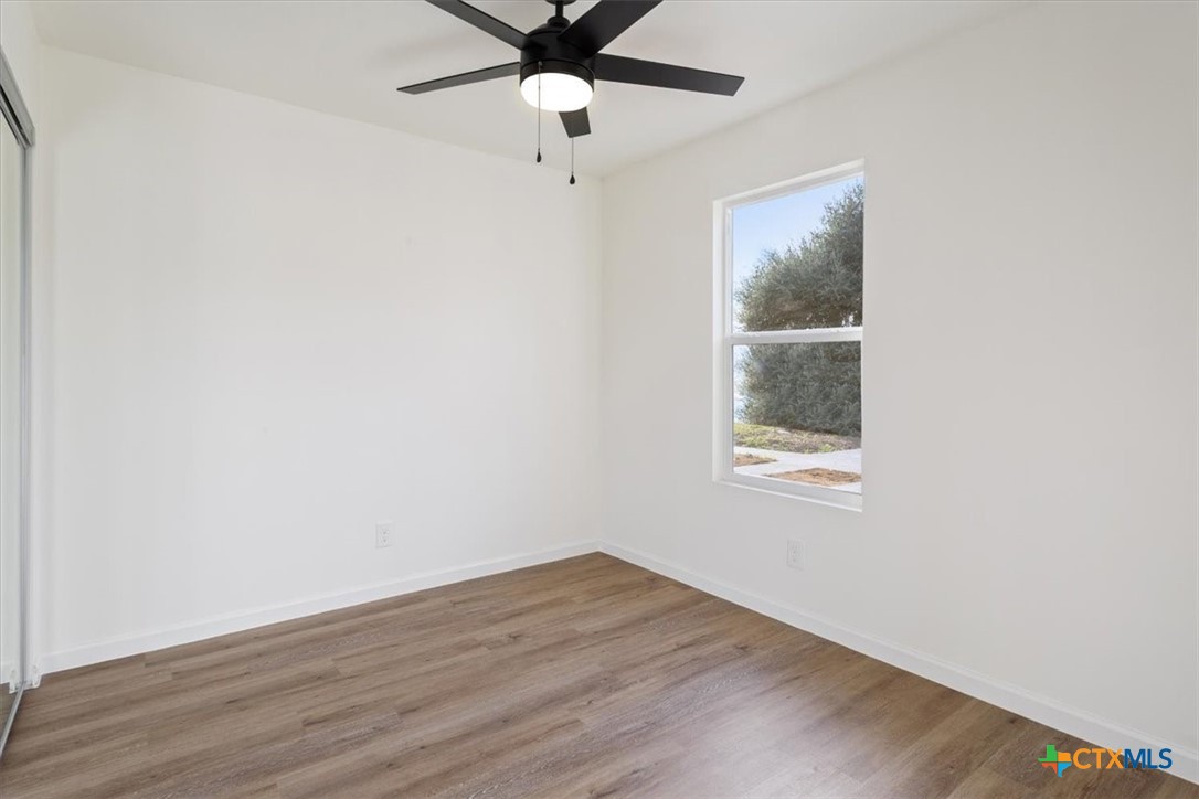 707 South 13th Street Temple, TX 76504 - Photo 19 of 24 wooden floor in an empty room with a window