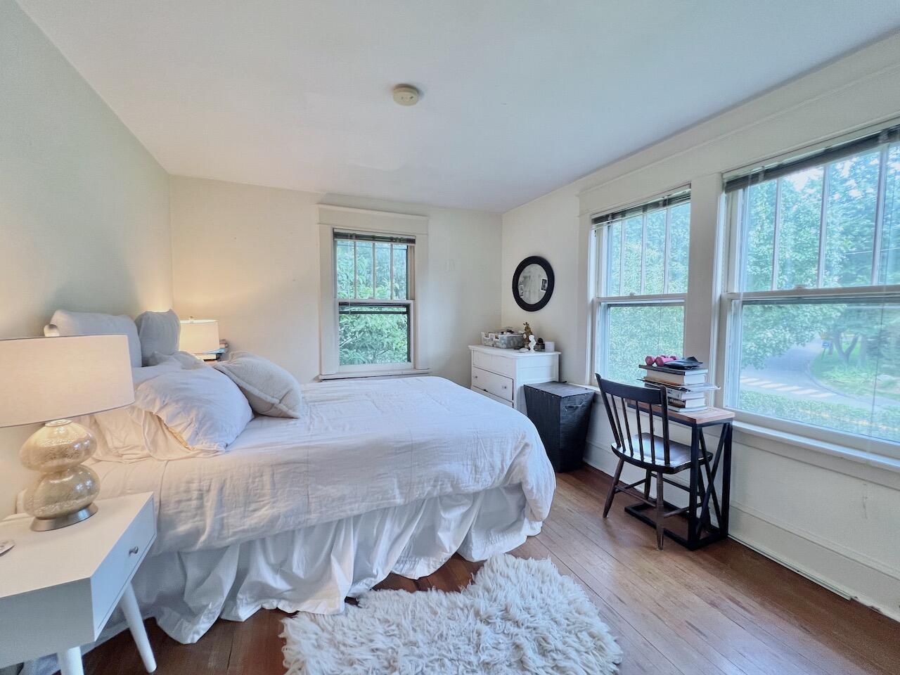 319 Rowayton Avenue Rowayton, CT 06853 - Photo 18 of 25 a bedroom with a bed a table and windows