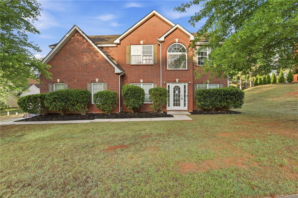 4968 Locherby Drive Fairburn, GA 30213 - Photo 1 of 39 a front view of a house with a yard and garage