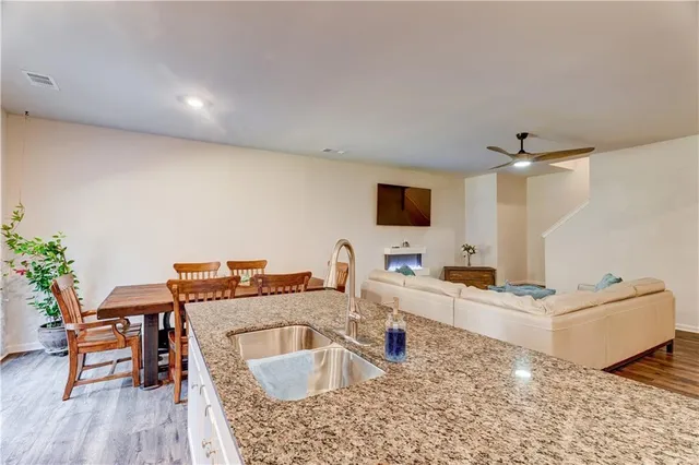 a bedroom with a bed couch and ceiling fan