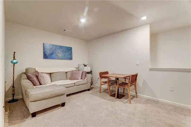 a view of a swimming pool with a lawn chairs and fire pit