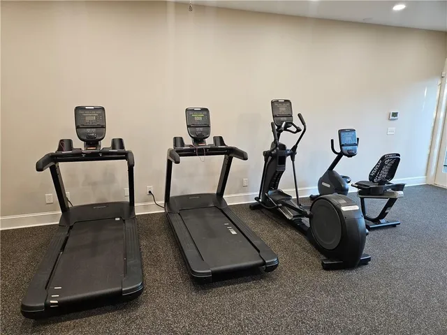 a dining room with furniture and a potted plant
