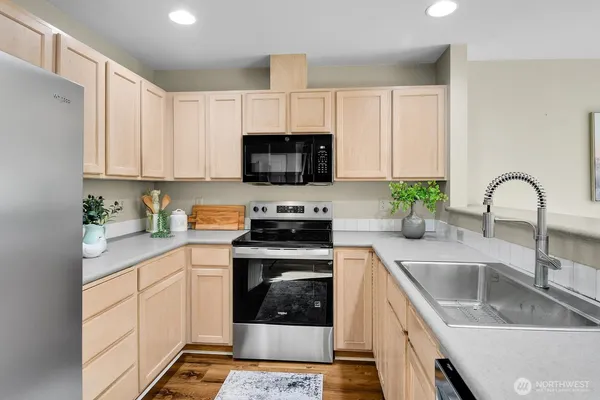 a kitchen with a sink stove and cabinets