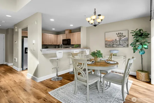 a view of a dining room with furniture and chandelier