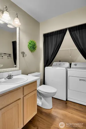 a bathroom with a toilet sink and mirror