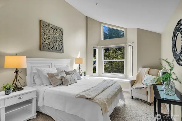 a bedroom with a bed and a window