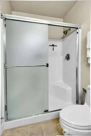 a bathroom with a shower and a toilet