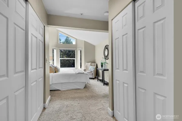 a view of a hallway with furniture and a livingroom view