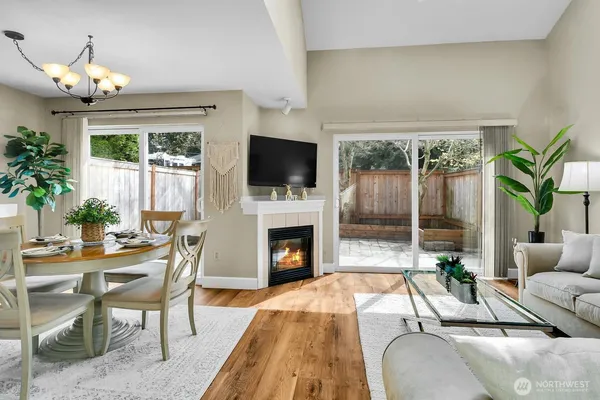 a living room with furniture fireplace and potted plants