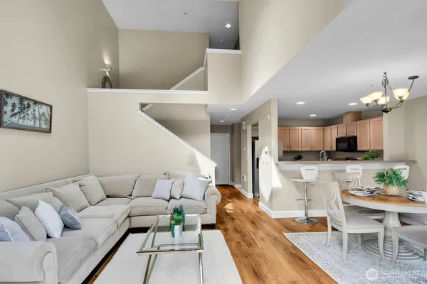 a living room with furniture and a dining table with kitchen view