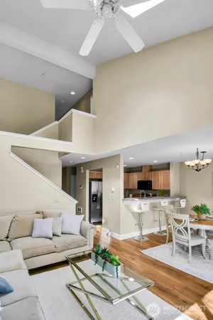 a living room with furniture and view of kitchen