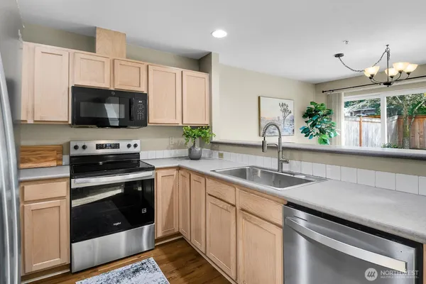 a kitchen with a sink stove and microwave